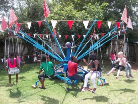 Children riding a 12-seater swing