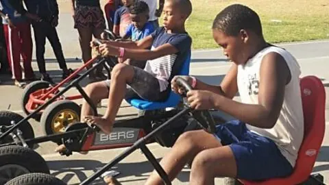 Children racing on pedal go-karts
