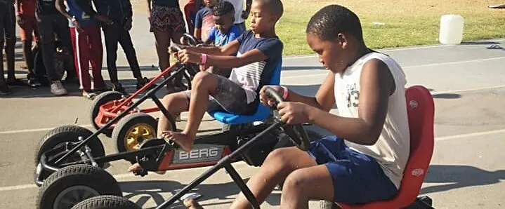 Children riding Bakiddies pedal go-karts